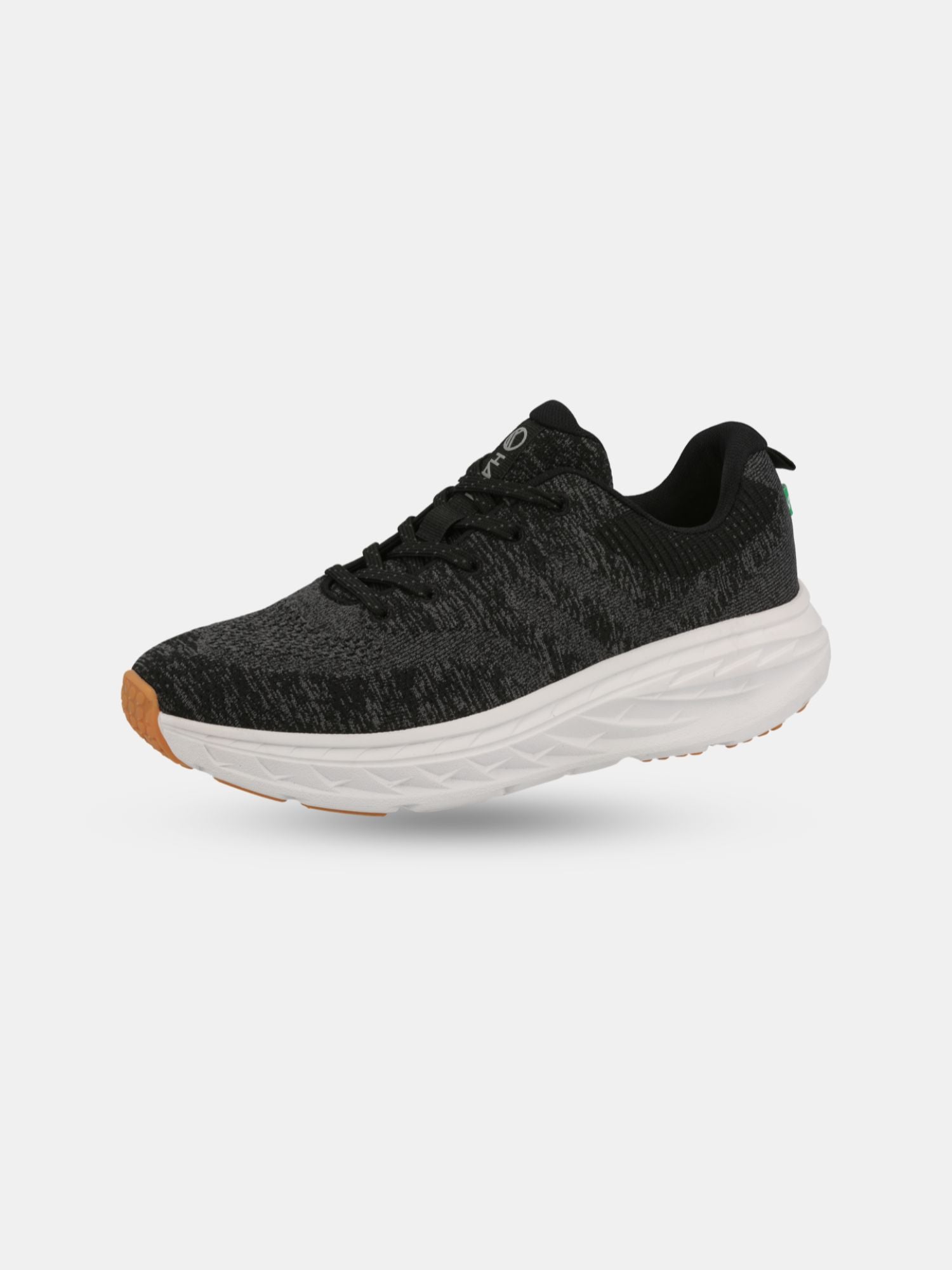 Halti Stem Sneaker Herr har en svart design, vit sula och tådetaljer i sjögräs på en enfärgad bakgrund.