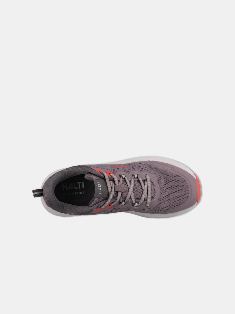 Halti Rapid 2 Sneaker Dam: Grå träningssko med orangefärgade detaljer, snörning och Halti-märke synligt på innersulan.