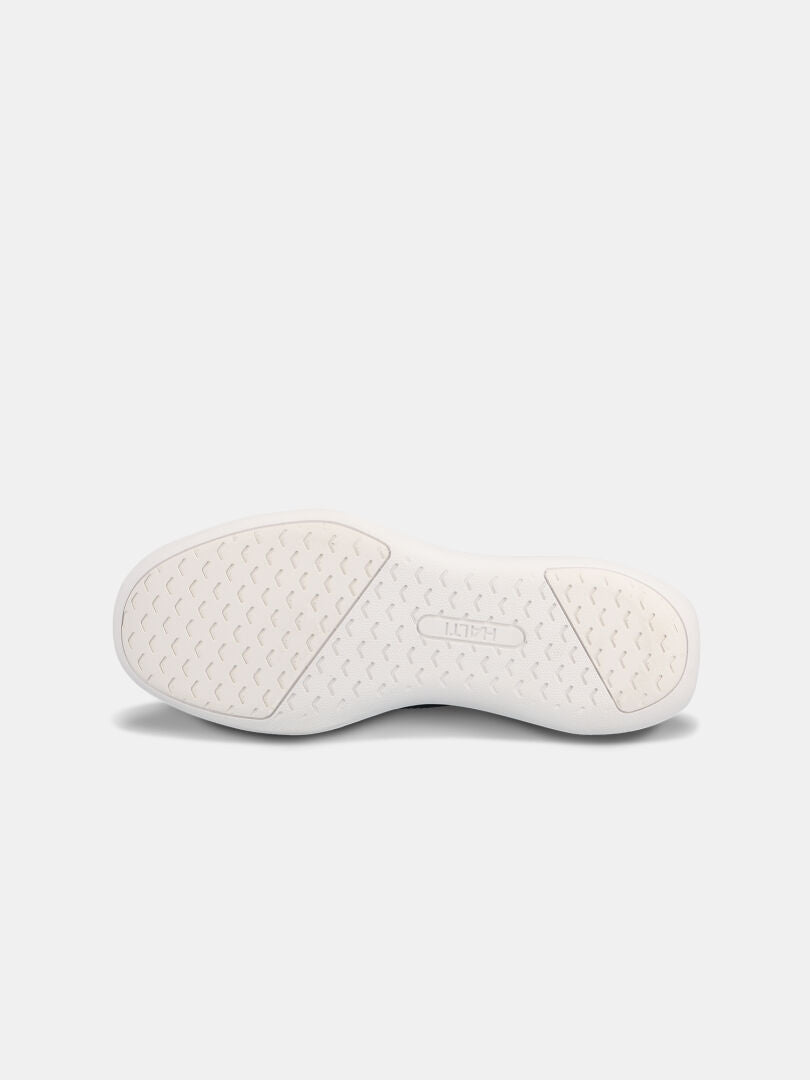 Halti Snabb 2 StepIn Sneaker Herr har en vit texturerad gummisula med en rektangulär logotyp i mitten.