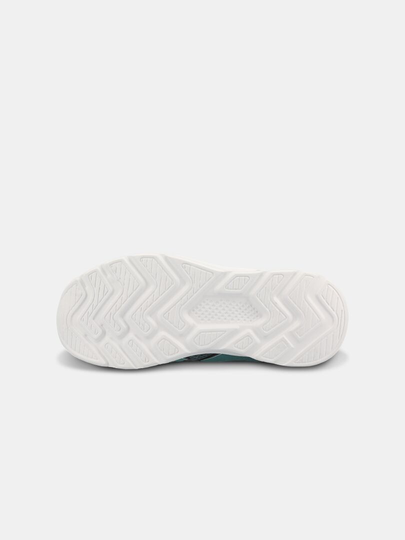 Den vita gummiyttersulan på Haltis Merry 2 Sneaker Junior har ett sicksackmönster mot en enkel bakgrund.