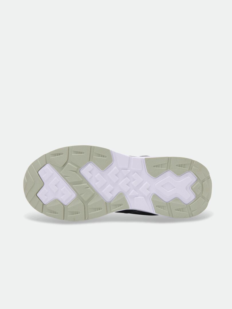 Sulan på Halti Zuma Mid DX Sneaker Junior, beige och vit med struktur, avbildad mot en enfärgad ljus bakgrund.