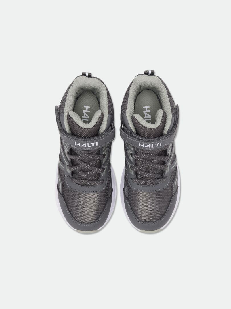 Ett par Halti Zuma Mid DX Sneaker Junior med kardborreband, sett uppifrån mot en vit bakgrund.
