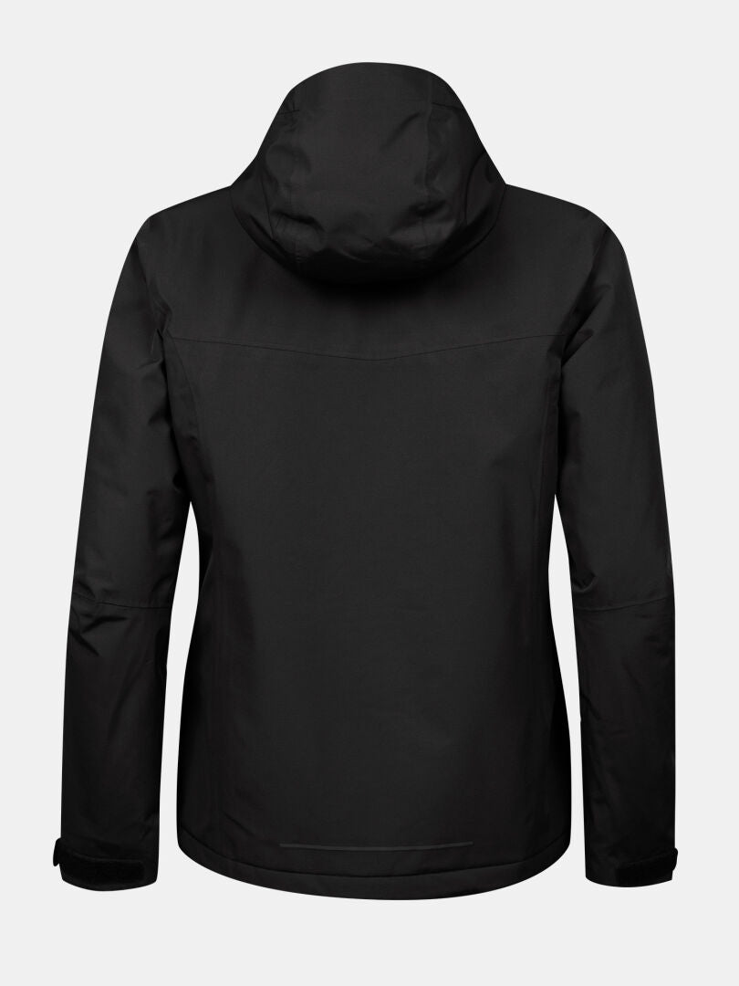 Bakifrån på Halti Forter DX Skaljacka Plus Dam i svart med långa ärmar, mot en ljus bakgrund.