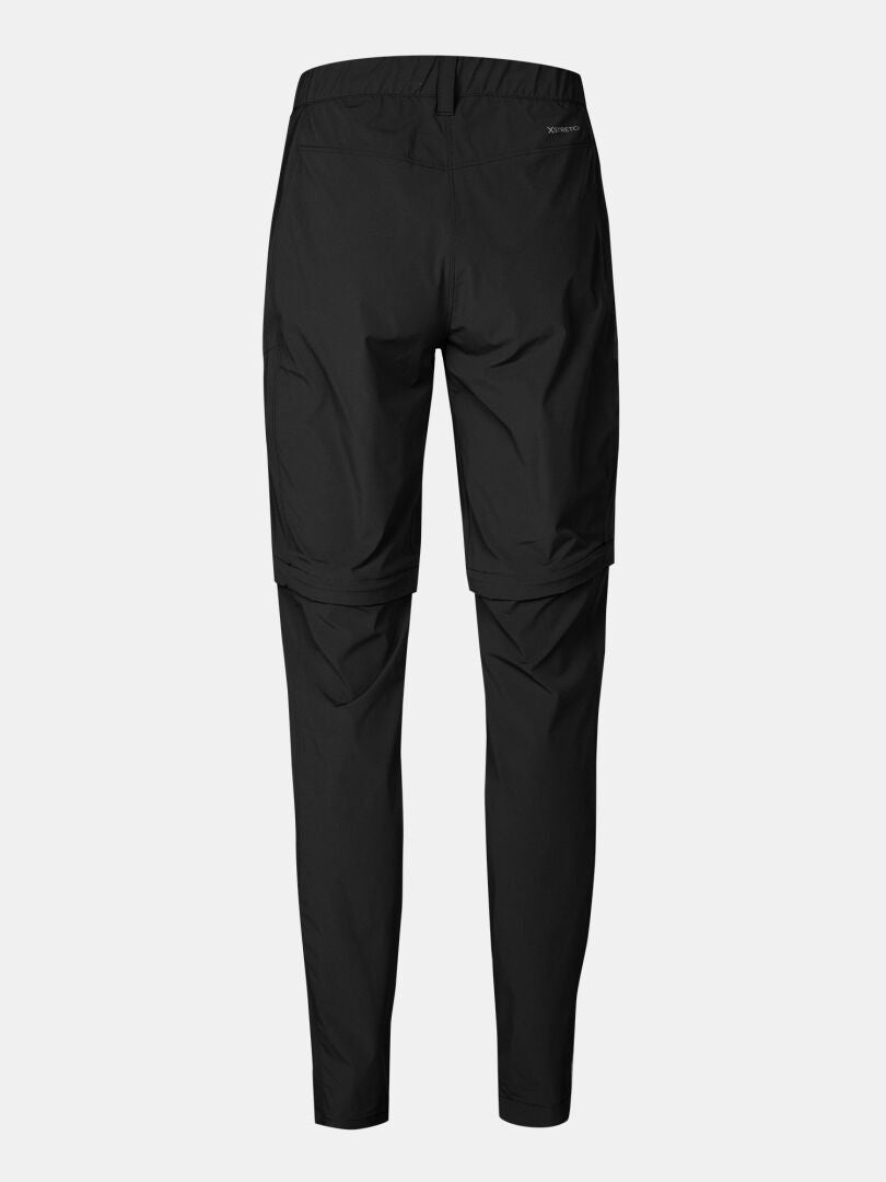 Halti Pallas Cool Stretch Zip-off Byxor Dam, visad bakifrån med underbenen avtagna mot en ljus bakgrund.