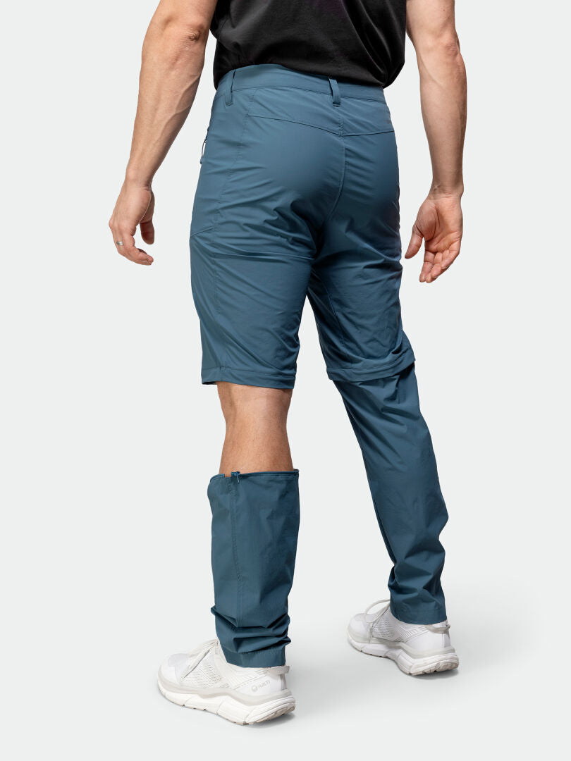 En person i Halti Pallas Cool Stretch Zip-off Byxor Herr - ett ben som shorts, ett helt, perfekt snabbtorkande byxor.