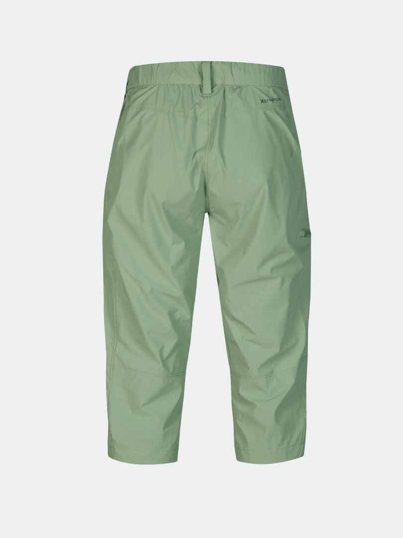 Halti Pallas Cool X-stretch Capribyxor Dam Plus i ljusgrönt, resår i midjan, bakifrån mot vit bakgrund.