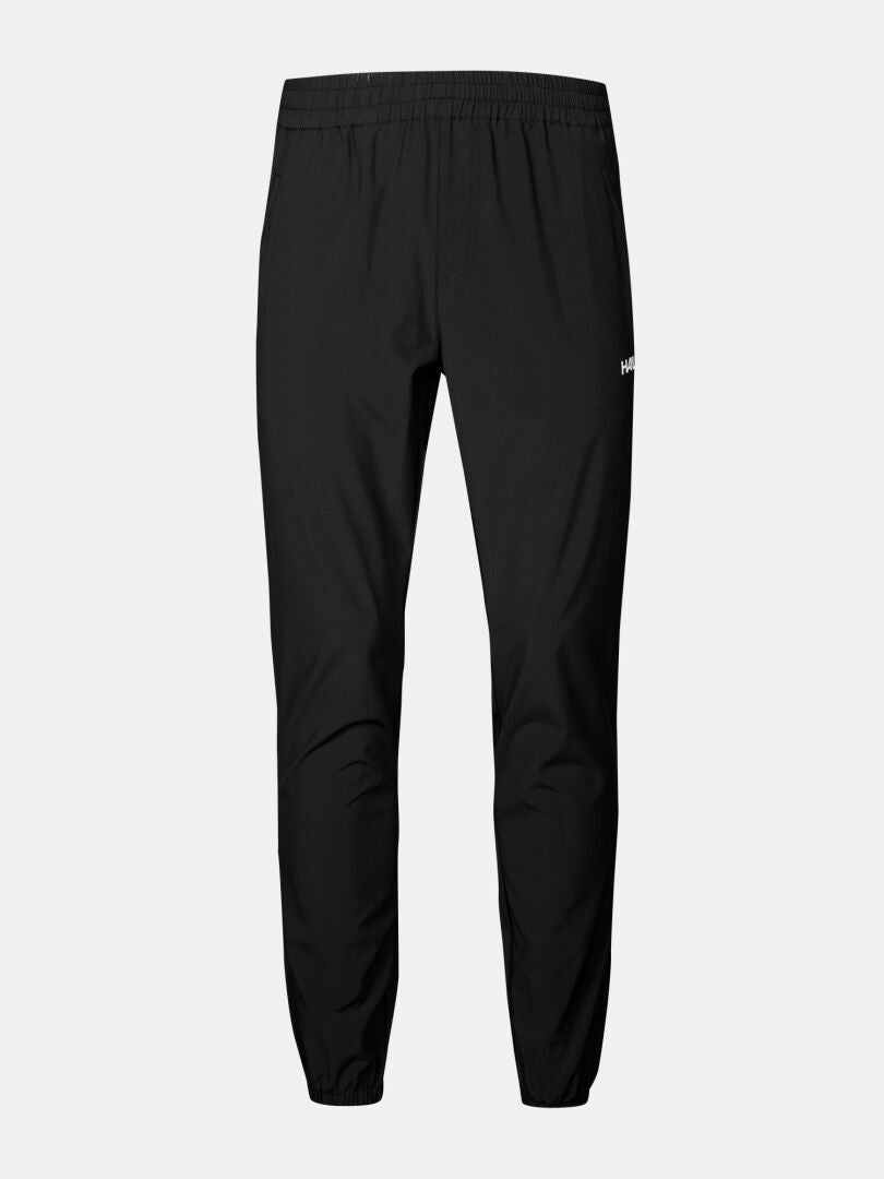 Halti Grets Joggers Herr: Svarta joggers med elastisk midja/avslut, liten vit logotyp, Quick Dry Lite Stretch-tyg.