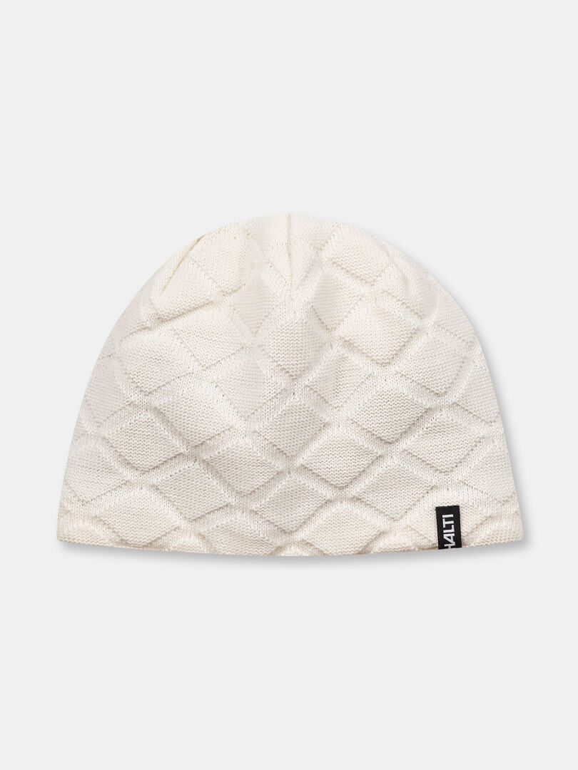 Halti Crostie Merinomössa är en vit stickad mössa med diamantquiltning och en liten svart tagg på kanten.