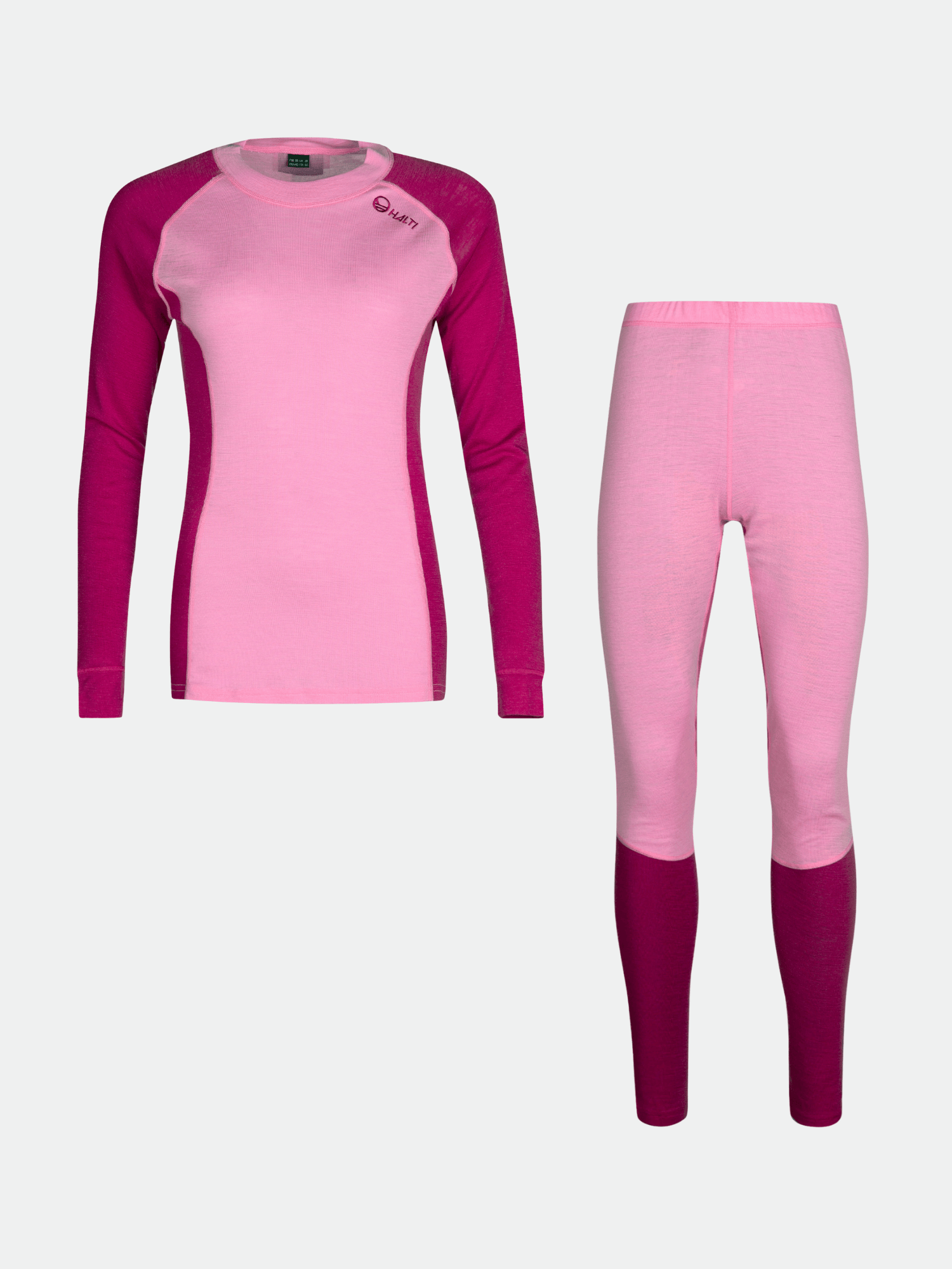 Halti Hossa Merinoull Underställ Set Dam i rosa och magenta mot en enfärgad bakgrund.