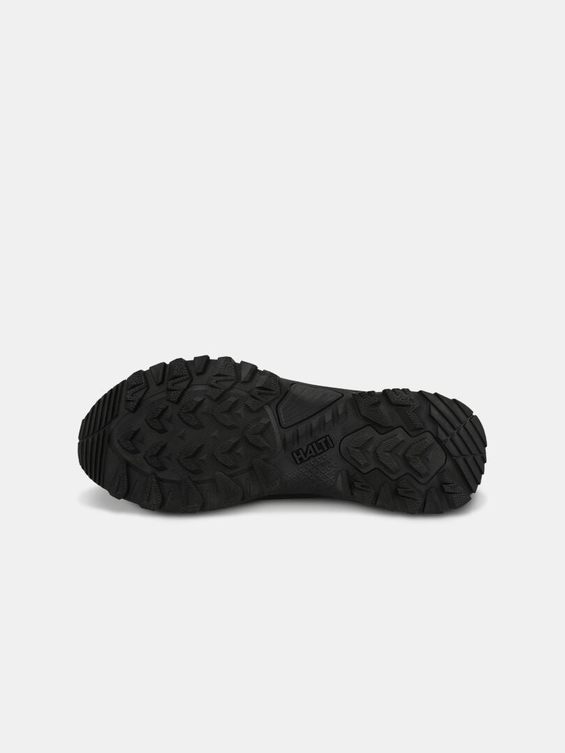 Halti Fara Low 2 DX Freelock Outdoor Skor har en svart, slitstark gummisula, avbildad mot en vit bakgrund.