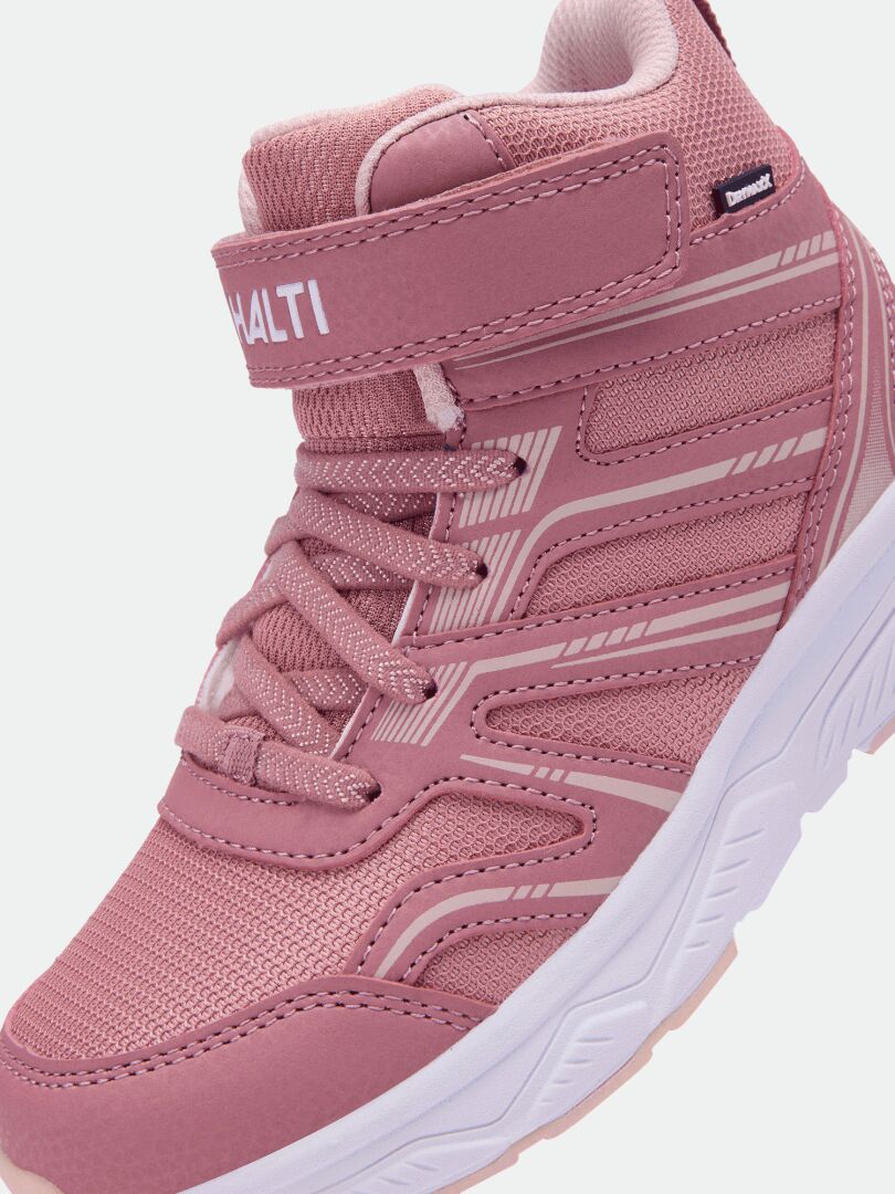 Halti Zuma Mid DX Sneaker Junior i rosa har kardborreband, nätpaneler och en tjock vit sula – sett från sidan.