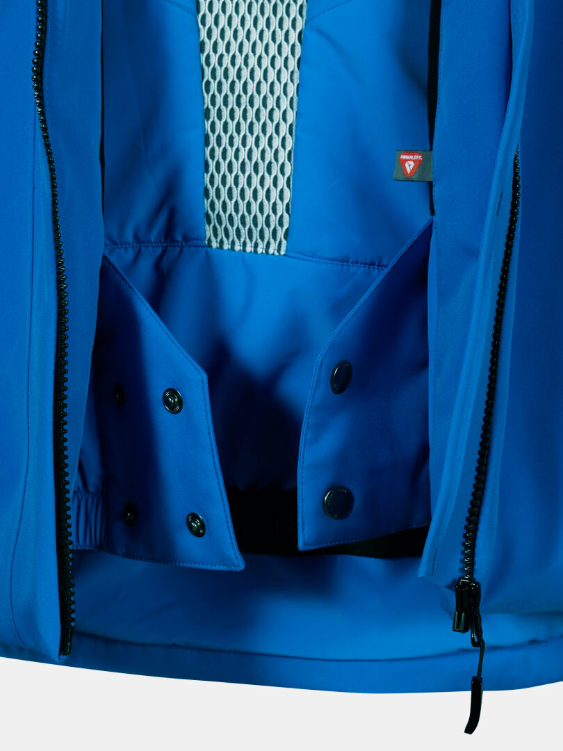 Närbild av Vertica DX Skidjacka Herr från Halti: blå, meshfoder, svarta tryckknappar och delvis öppet blixtlås.
