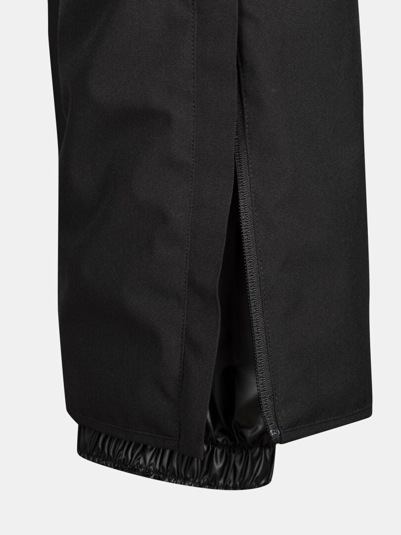 Närbild av Halti Glades II DX Skidbyxor Dam som visar ett vertikalt blixtlås som är delvis öppet och avslöjar en elastisk manschett undertill.