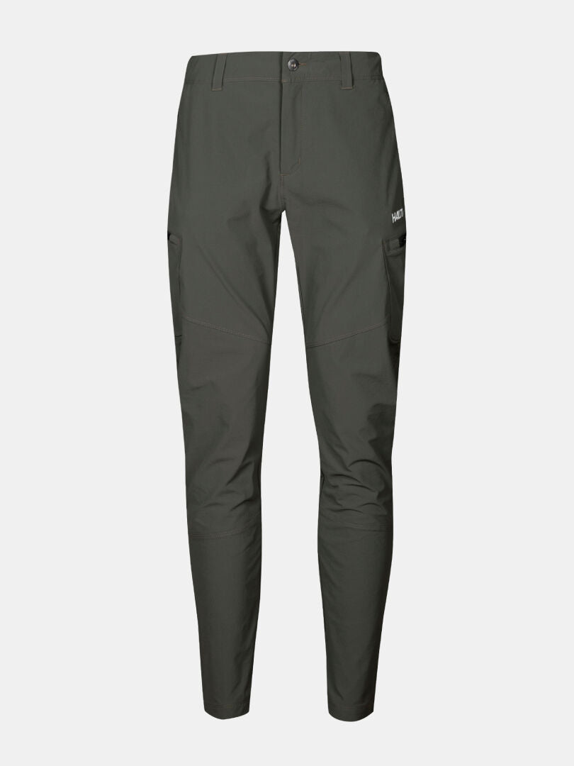 Halti Pallas Evo X-stretch Byxor Dam: mörkgröna, slim-fit byxor med sidofickor och knappstängning på vit bakgrund.