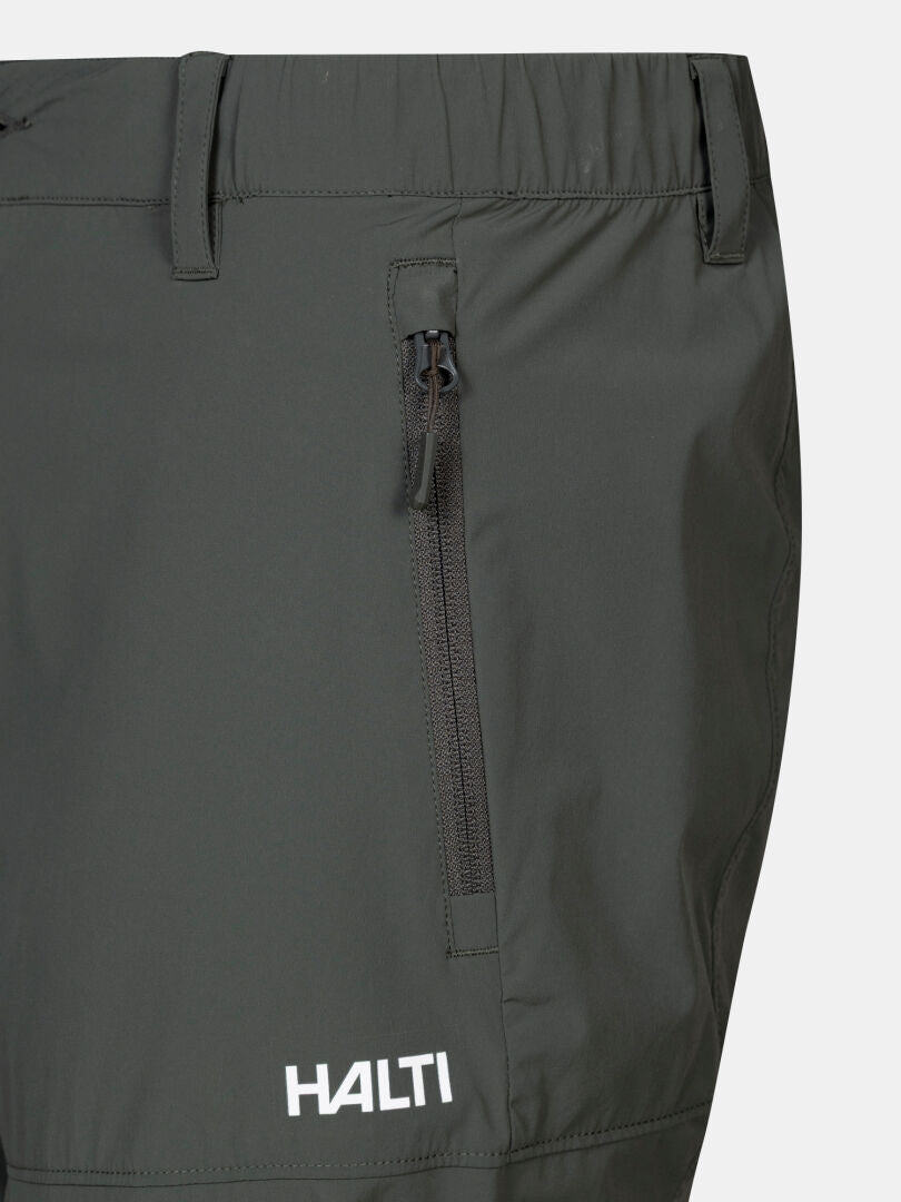 Närbild på Halti Pallas Cool X-stretch capribyxor herr i mörkgrått med ficka med dragkedja framtill och logotyp nära nederkanten.