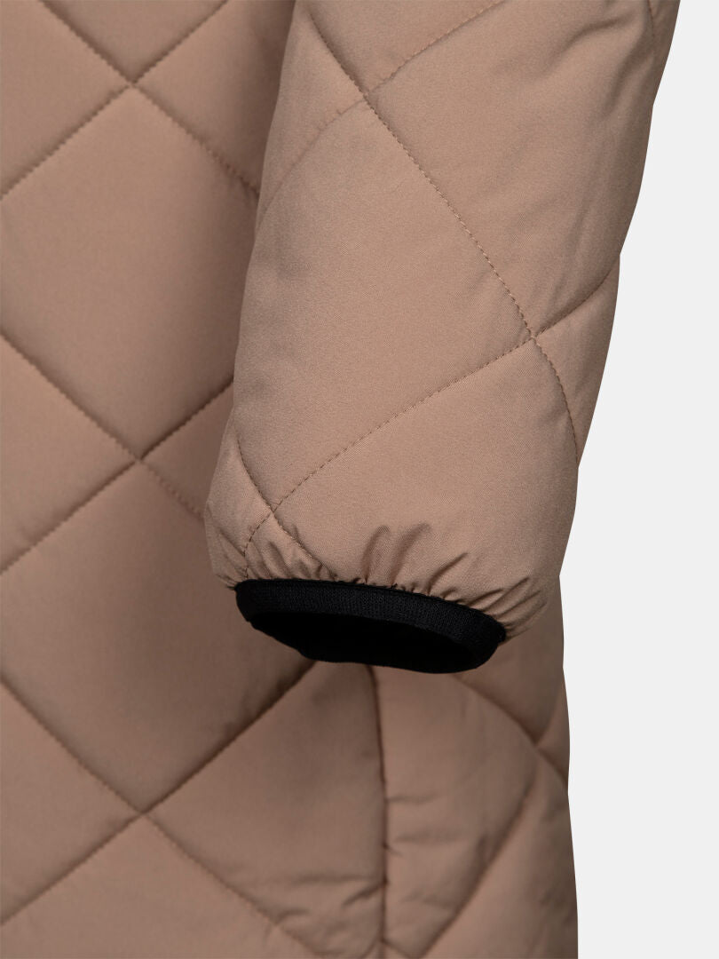 Närbild på en Haapa Vadderad Jacka Dam-ärmskydd från Halti, beige med svart manschett, mot en enfärgad vit bakgrund.