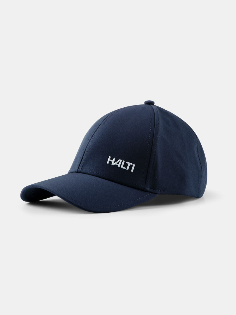 En marinblå Mattas Baseball Keps by Halti med UPF 50+ och vitt Halti-broderi på framsidan, visad på en enfärgad bakgrund.