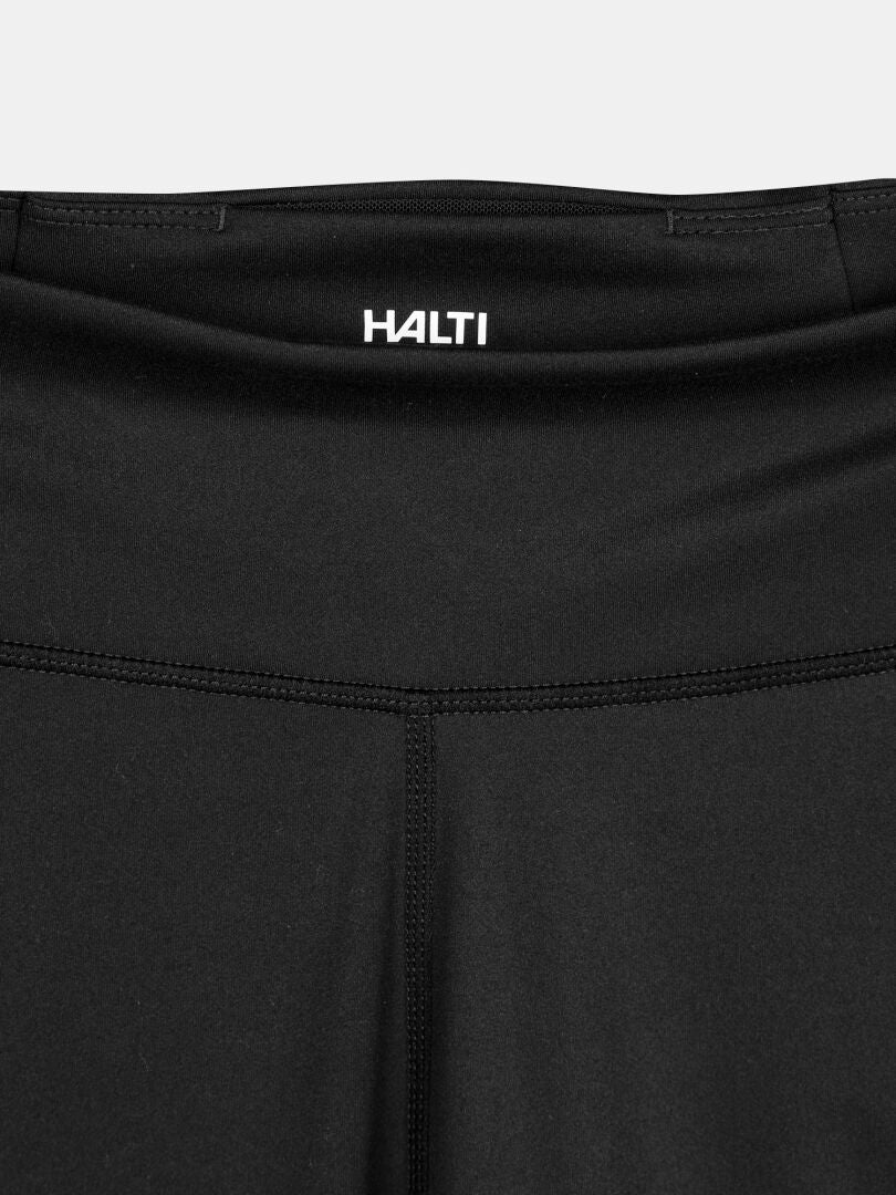 Närbild av midjeband och övre del av Kaldu Träningstights Dam från Halti, logotyp tryckt på midjeband.