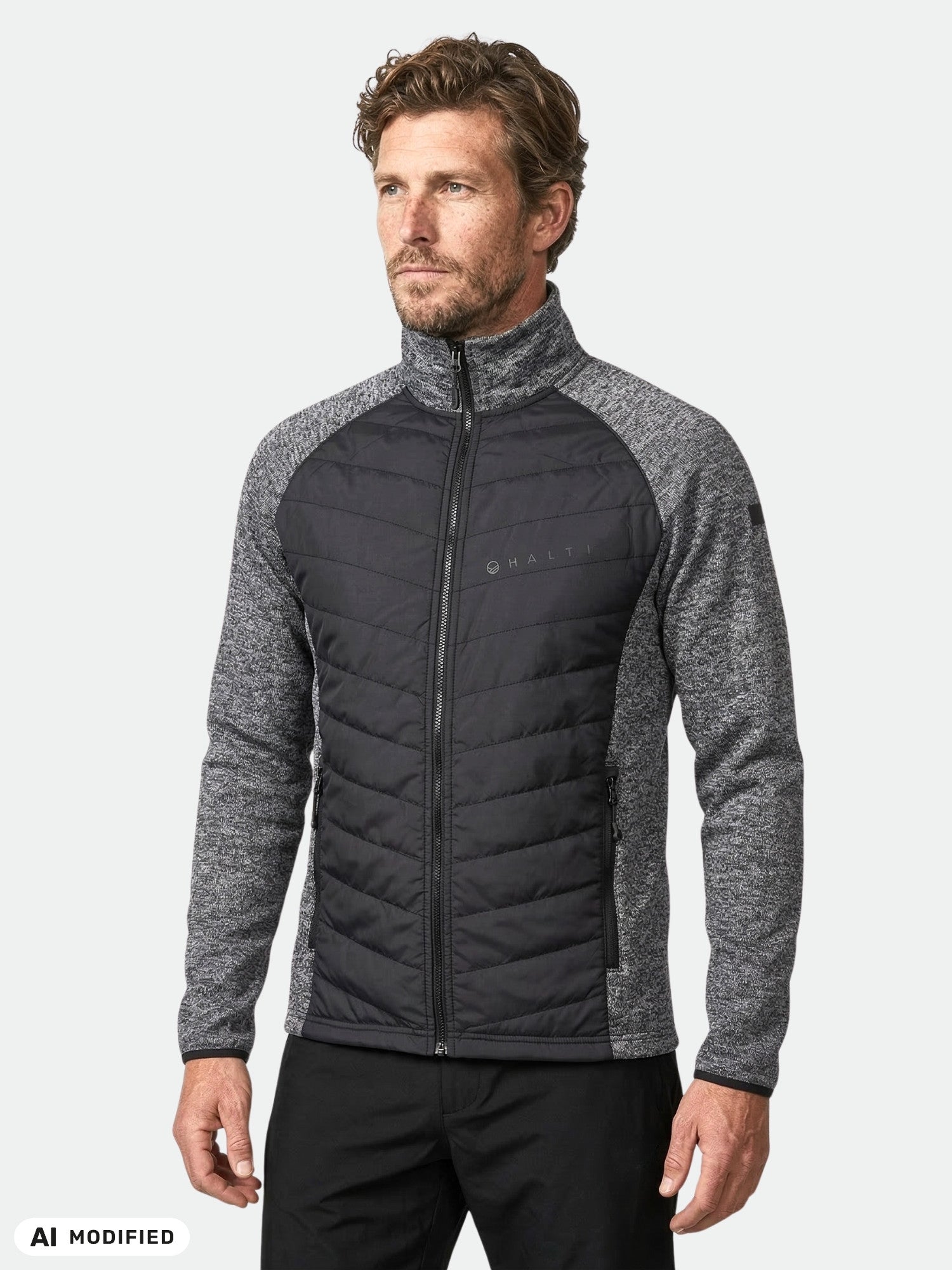 Man i Halti Streams Hybrid Mellanlager Herr, svart/grå med quiltade detaljer, mot en enkel bakgrund.